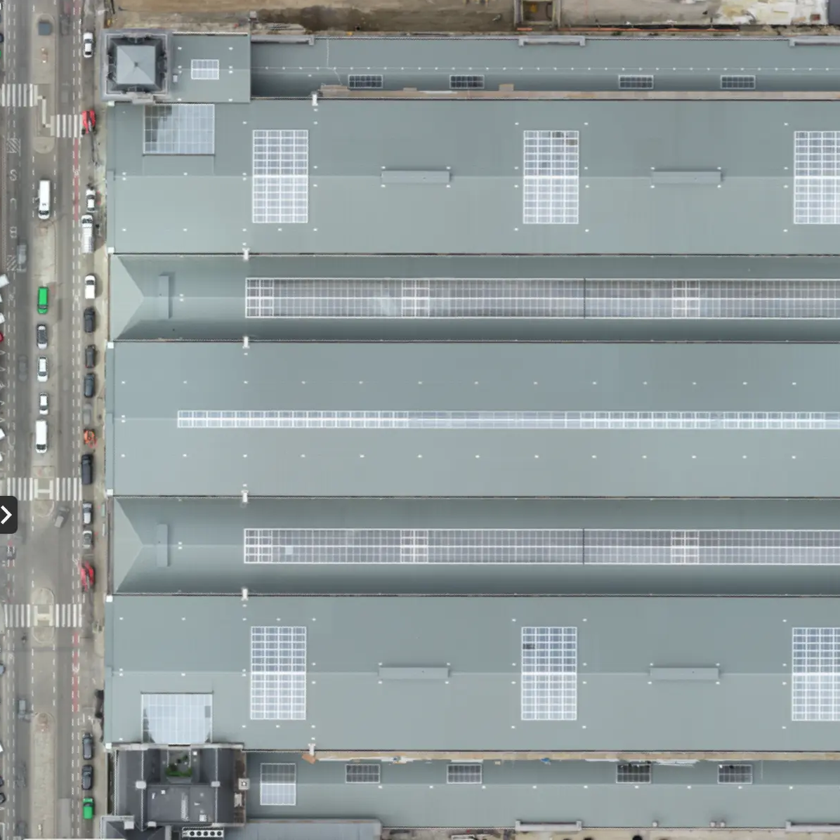 Brown leather key ring with brass metal loops and rivets on wood table.